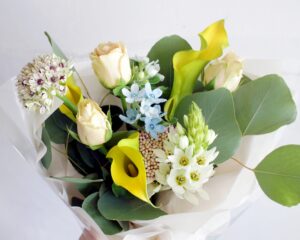 プロポーズのプレゼントに私的な白バラと黄色いカラー、青いブルースターと白いオーニソガラムの花束